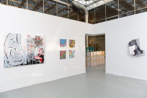 A room with art on the wall Description automatically generated