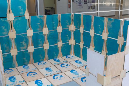 A room with blue tiles and wooden walls Description automatically generated with medium confidence