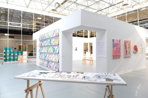 A white room with a table and books on it Description automatically generated