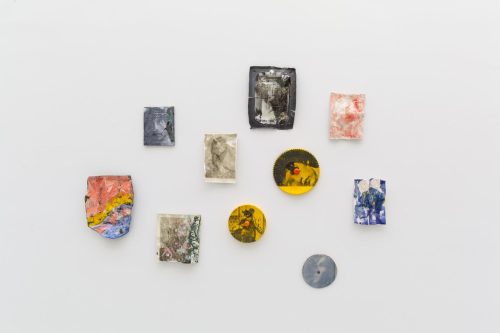 Several pieces of art on a white surface Description automatically generated