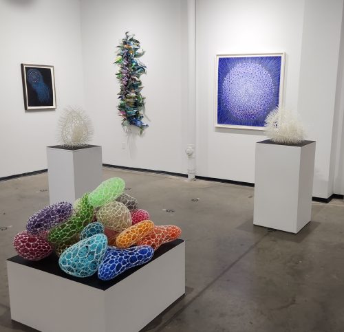 A group of art pieces in a room Description automatically generated