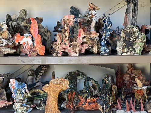 A shelf with different colored objects Description automatically generated