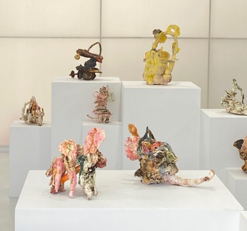 Several pieces of art on a white cube Description automatically generated with medium confidence