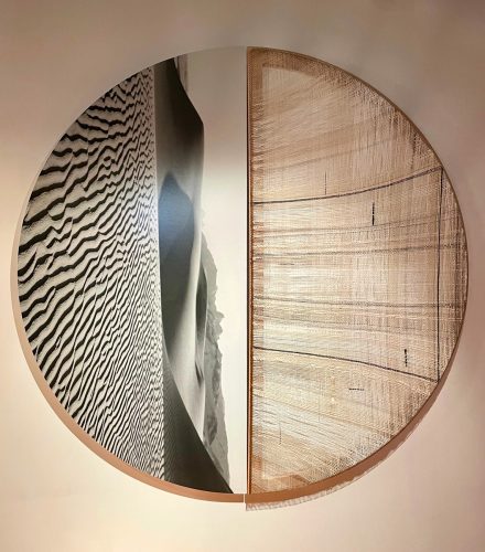 A circular object with a picture of sand dunes Description automatically generated