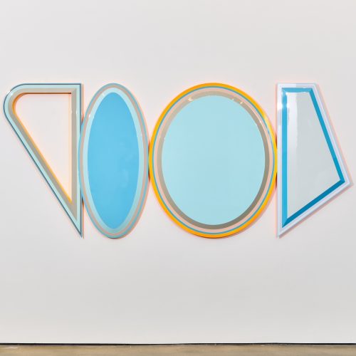 A group of blue and orange shapes on a white wall Description automatically generated