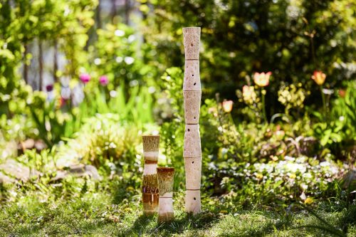 A group of stacked ceramic objects in a garden Description automatically generated
