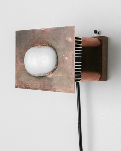 A metal box with a white circle on it Description automatically generated