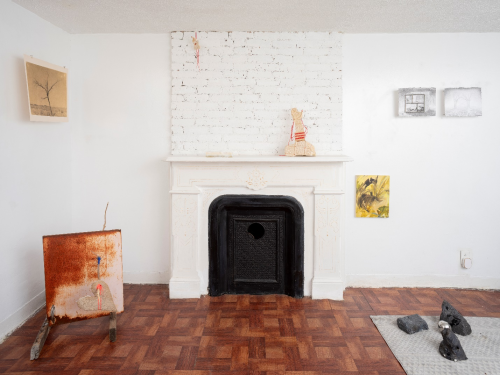 A room with a fireplace and a rug Description automatically generated