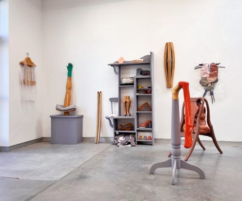 A room with a variety of objects on the wall Description automatically generated