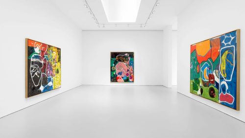 A room with paintings on the wall Description automatically generated