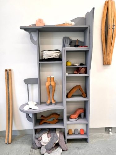 A shelf with shoes and objects on it Description automatically generated