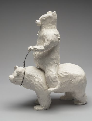 A white bear statue on top of a bear Description automatically generated