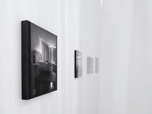 A black and white picture on a white wall Description automatically generated