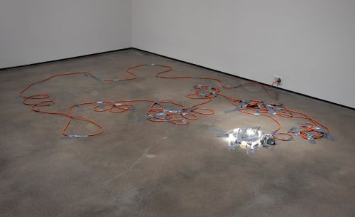 A bunch of wires on the floor Description automatically generated