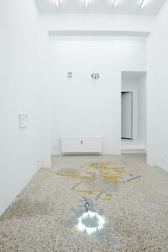 A room with a white wall and a white floor Description automatically generated