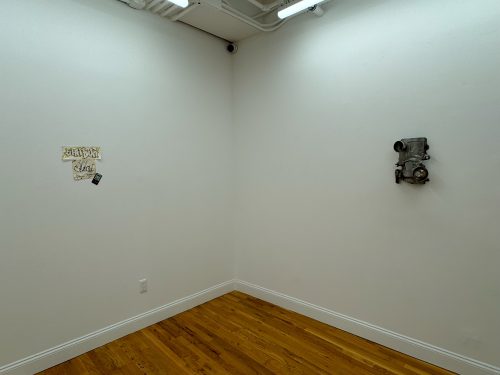 A room with a white wall and wood floor Description automatically generated