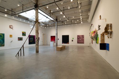 A room with art on the wall Description automatically generated