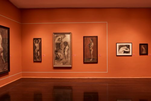 A group of paintings on a wall Description automatically generated