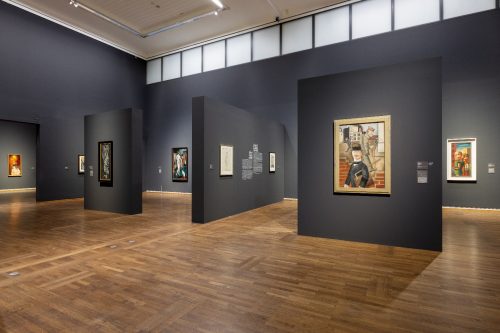 A room with art on the walls Description automatically generated