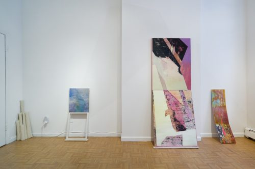 Several art pieces on display in a room Description automatically generated