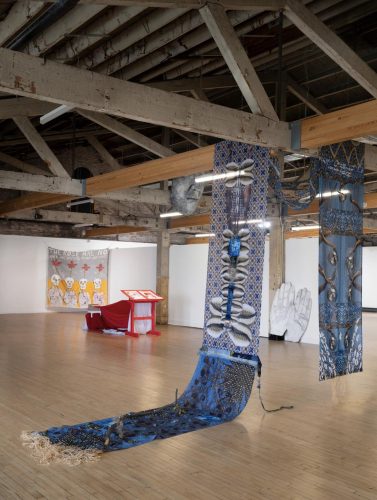 A large room with a large blue curtain Description automatically generated with medium confidence