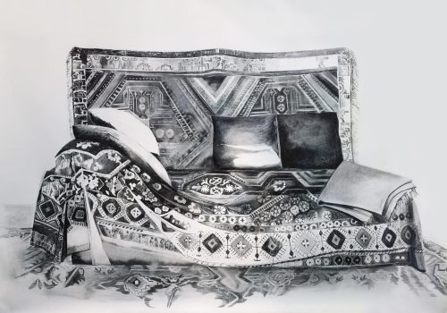 A couch with pillows and blankets Description automatically generated