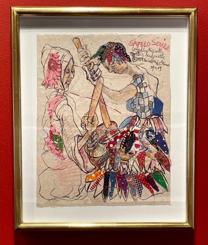 A framed picture of two women in dresses Description automatically generated