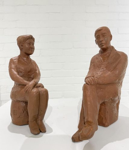 A clay statue of two people AI-generated content may be incorrect.