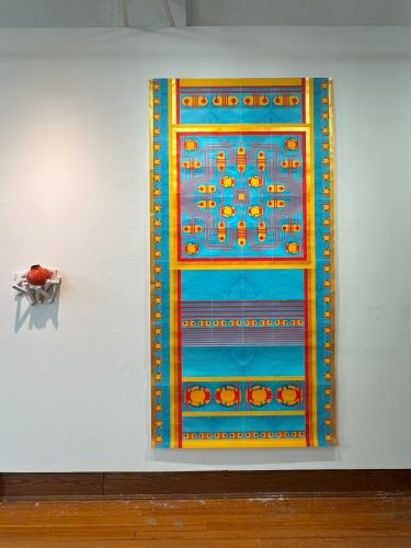 A blue and yellow art piece on a white wall AI-generated content may be incorrect.