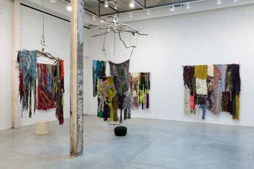 A room with multiple pieces of fabric on a white wall AI-generated content may be incorrect.