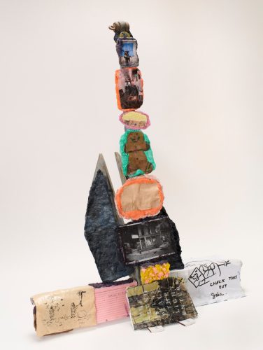 A sculpture of a tower made of colorful objects AI-generated content may be incorrect.