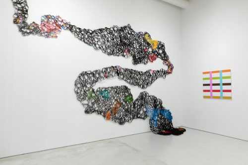 A wall with a sculpture of a person in the shape of a snake AI-generated content may be incorrect.