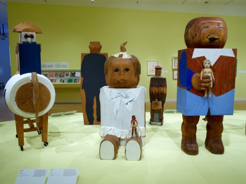 A group of wooden sculptures in a museum AI-generated content may be incorrect.