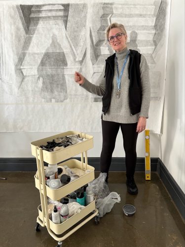 A person standing next to a cart with tools AI-generated content may be incorrect.