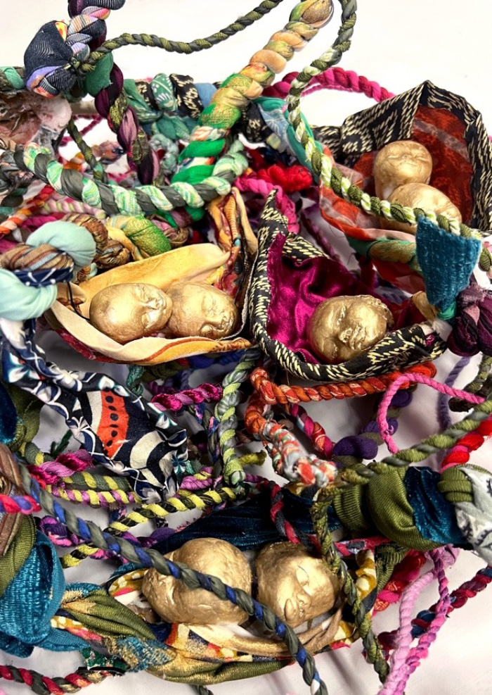A pile of colorful fabric and gold objects

AI-generated content may be incorrect.